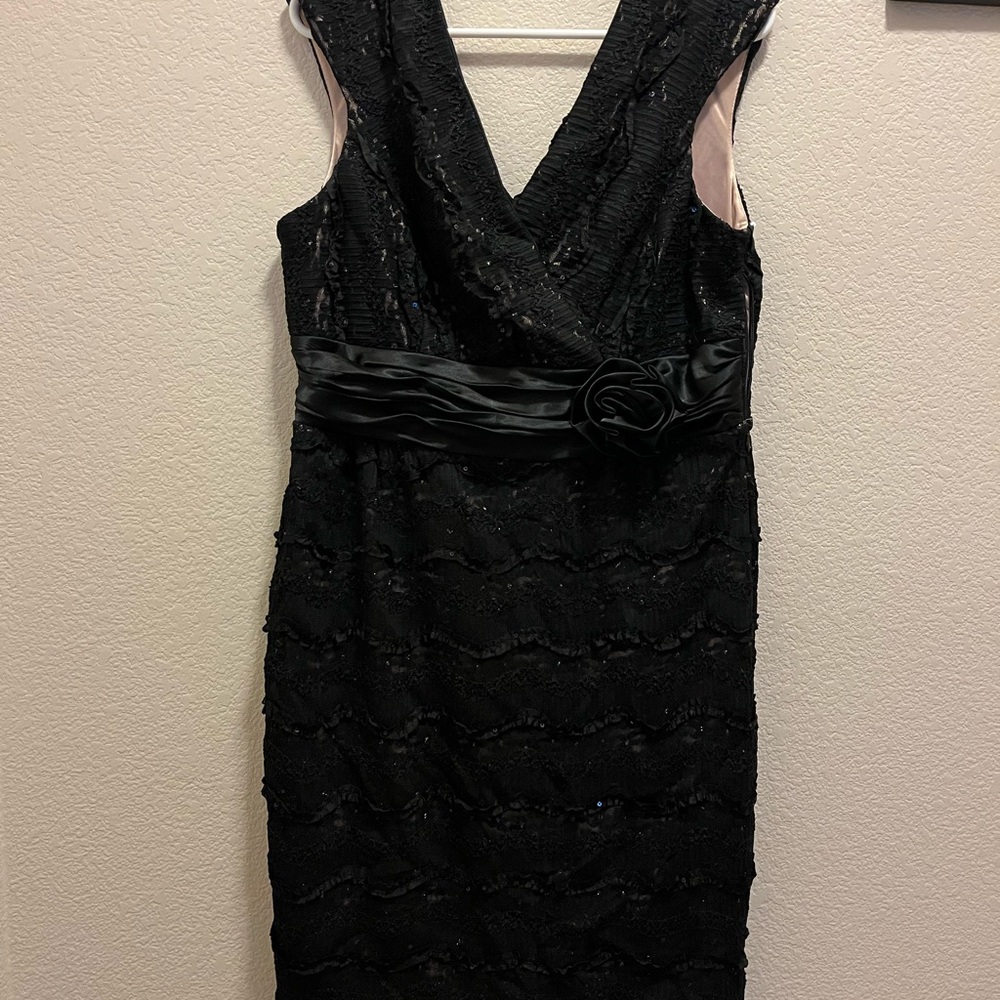 Women’s black dress with rose on waist